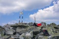 Man resting on top of a mountain