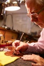 Man Restoring Violin In Workshop Royalty Free Stock Photo