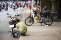 Man rests on scooter in Ho Chi Minh City, Vietnam