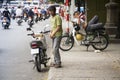 Man rests on scooter in Ho Chi Minh City, Vietnam