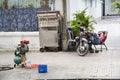 Man rests on scooter on street of Ho Chi Minh City, Vietnam