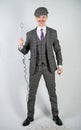Man in a retro suit stands and holds a vintage water boiler on a white Studio background alone