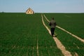 The man returns home on the road among the green field Royalty Free Stock Photo