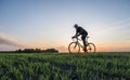 Man ride a bicycle in sunset. Riding a Bicycle at Sunset. Healthy Lifestyle Concept. Male ride bicycle in sun set. Biker