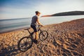 Man ride mountain bike on the beach. Royalty Free Stock Photo