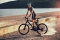 Man ride mountain bike on the beach. Royalty Free Stock Photo