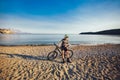 Man ride mountain bike on the beach. Royalty Free Stock Photo