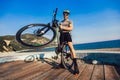 Man ride mountain bike on the beach. Royalty Free Stock Photo