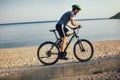 Man ride mountain bike on the beach. Royalty Free Stock Photo