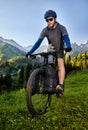 Man ride mountain bike at the green hill in the mountain of Kazakhstan