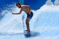 Man ride a surfing board on FlowRider