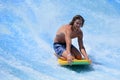 Man ride a surfing board on FlowRider