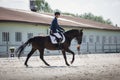 Man rider and black stallion horse galloping during equestrian dressage competition Royalty Free Stock Photo