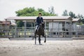 Man rider and black stallion horse galloping during equestrian dressage competition Royalty Free Stock Photo