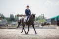 Man rider and black stallion horse trotting fast Royalty Free Stock Photo