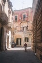 A man rides a bicycle in the street in Lecce, Puglia, Italy