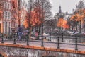 Man rides a bike on the bridge over the Amsterdam canal. Daytime Royalty Free Stock Photo