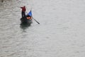 A man rides a boat in Venice. Travel to Venice , Italy