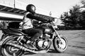Man rides a motorcycle in the city.Motorcyclist riding a bike during the day on the road.Black and white photo Royalty Free Stock Photo