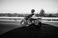 Man rides a motorcycle in the city.Motorcyclist riding a bike during the day on the road.Black and white photo Royalty Free Stock Photo