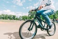 Man rides a mountain bike on a sunny summer day. Hipster rides a bike in the park Royalty Free Stock Photo
