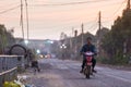 Man rides on old motorbike down the road at the Muslim district