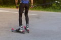 A man rides roller skis in a summer park.Cross country skiing Royalty Free Stock Photo