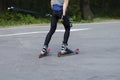 A man rides roller skis in a summer park.Cross country skiing Royalty Free Stock Photo