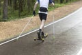 A man rides roller skis in a summer park.Fitness on the street Royalty Free Stock Photo