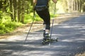A man rides a ski roller on an asphalt road in the Park in the summer Royalty Free Stock Photo