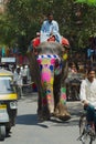 Man rides traditionally decorated elephant by the street near Amber fort in Jaipur, India.