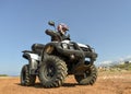 A man riding ATV in sand in a helmet. Royalty Free Stock Photo