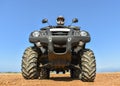 A man riding ATV in sand in a helmet. Royalty Free Stock Photo