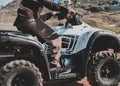 A man riding ATV in sand in a helmet. Royalty Free Stock Photo