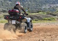 A man riding ATV in sand in a helmet. Royalty Free Stock Photo