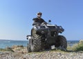 A man riding ATV in sand in a helmet. Royalty Free Stock Photo