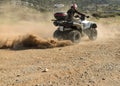 A man riding ATV in sand in a helmet. Royalty Free Stock Photo