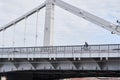 Man riding on bicycle across the bridge in the city. Royalty Free Stock Photo