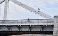 Man riding on bicycle across the bridge in the city. Royalty Free Stock Photo