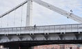 Man riding on bicycle across the bridge in the city. Royalty Free Stock Photo