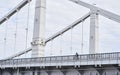 Man riding on bicycle across the bridge in the city. Royalty Free Stock Photo