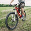 Man riding a bicycle along country road Royalty Free Stock Photo