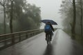 Man riding a bicycle in bad rainy weather