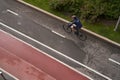 Man riding on bicycle on a bike path in the city. View from above. Royalty Free Stock Photo