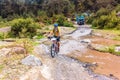 Man riding bicycle, crossing the river in the highlands of Guatemala