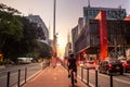 Man riding a bicycle on the Paulista Avenue bike path in front of the Arts Museum MASP Royalty Free Stock Photo
