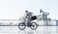 Man riding bicycle on penthouse balcony Royalty Free Stock Photo