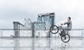 Man riding bicycle on penthouse balcony Royalty Free Stock Photo