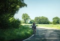 Man riding bicycle on remote rural road