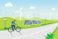 Man riding bicycle with solar panels and wind turbines background. Renewable, green and clean energy, reuse natural resources